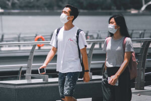 a couple walking in Singapore wearing masks